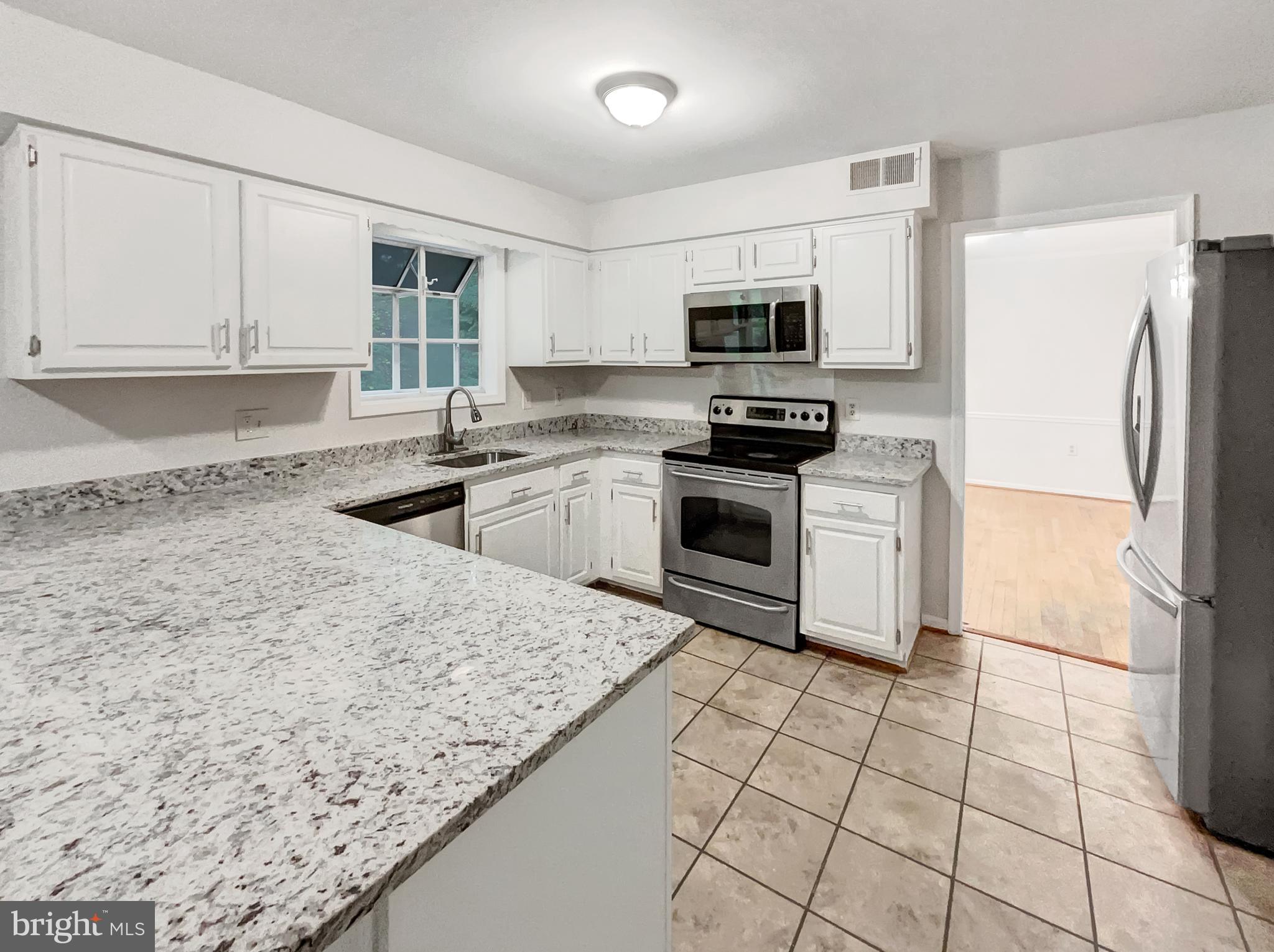 13109 Mica Court Silver Spring, MD 20904 - Photo 13 of 25 a kitchen with stainless steel appliances granite countertop a stove a sink and a refrigerator