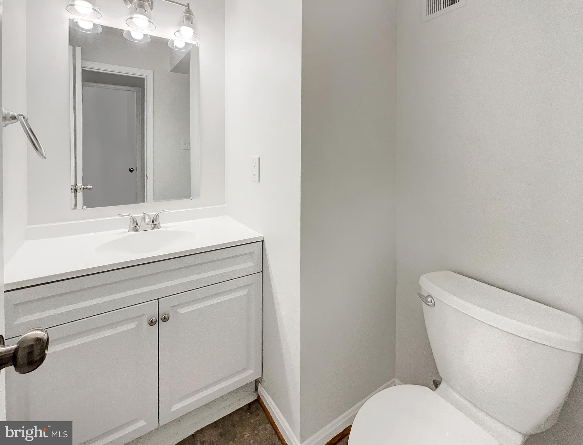 13109 Mica Court Silver Spring, MD 20904 - Photo 14 of 25 a bathroom with a toilet sink and mirror
