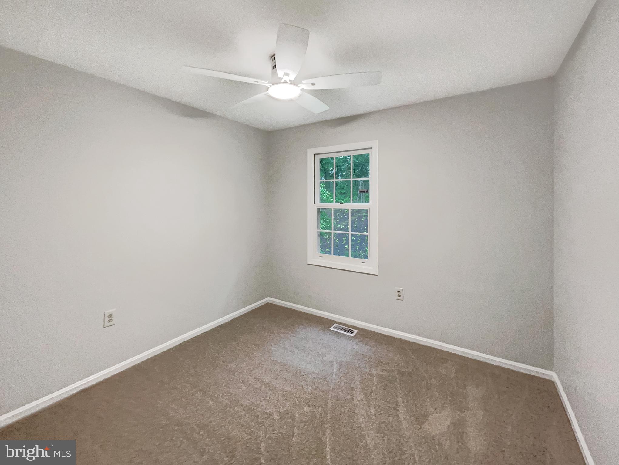 13109 Mica Court Silver Spring, MD 20904 - Photo 18 of 25 an empty room with windows and fan