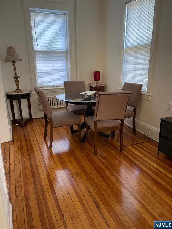 11 Preston Street, Unit 1E Ridgefield Park, NJ 07660 - Photo 4 of 12 a workspace with wooden floor and a table