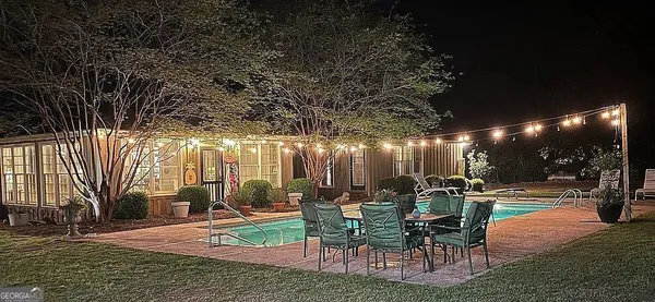 a view of a patio with dining table and chairs with a patio