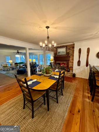 a living room with furniture a dining table and a fireplace