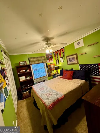 a bed sitting in a bedroom next to a window
