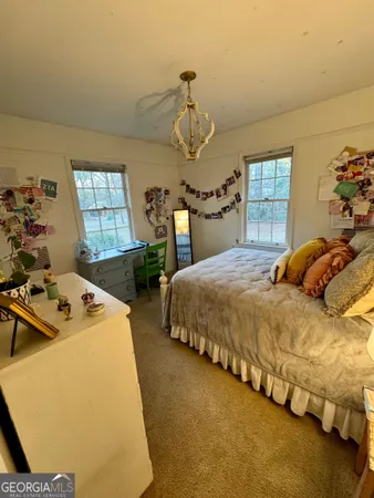 a bedroom with bed and window