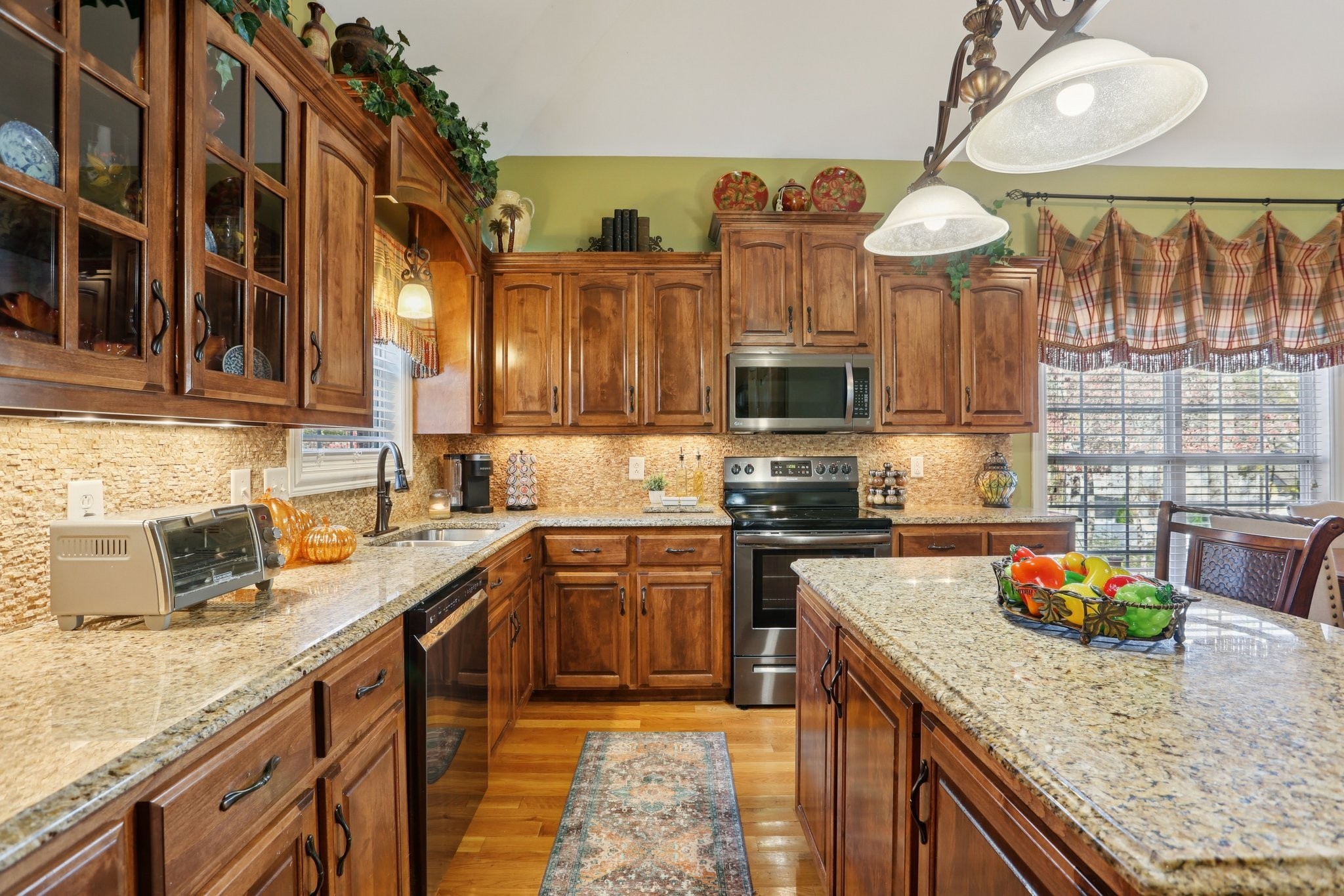 4015 Pilgrim Trail Greenbrier, TN 37073 - Photo 22 of 76 a kitchen with stainless steel appliances granite countertop a sink a stove and a wooden cabinets