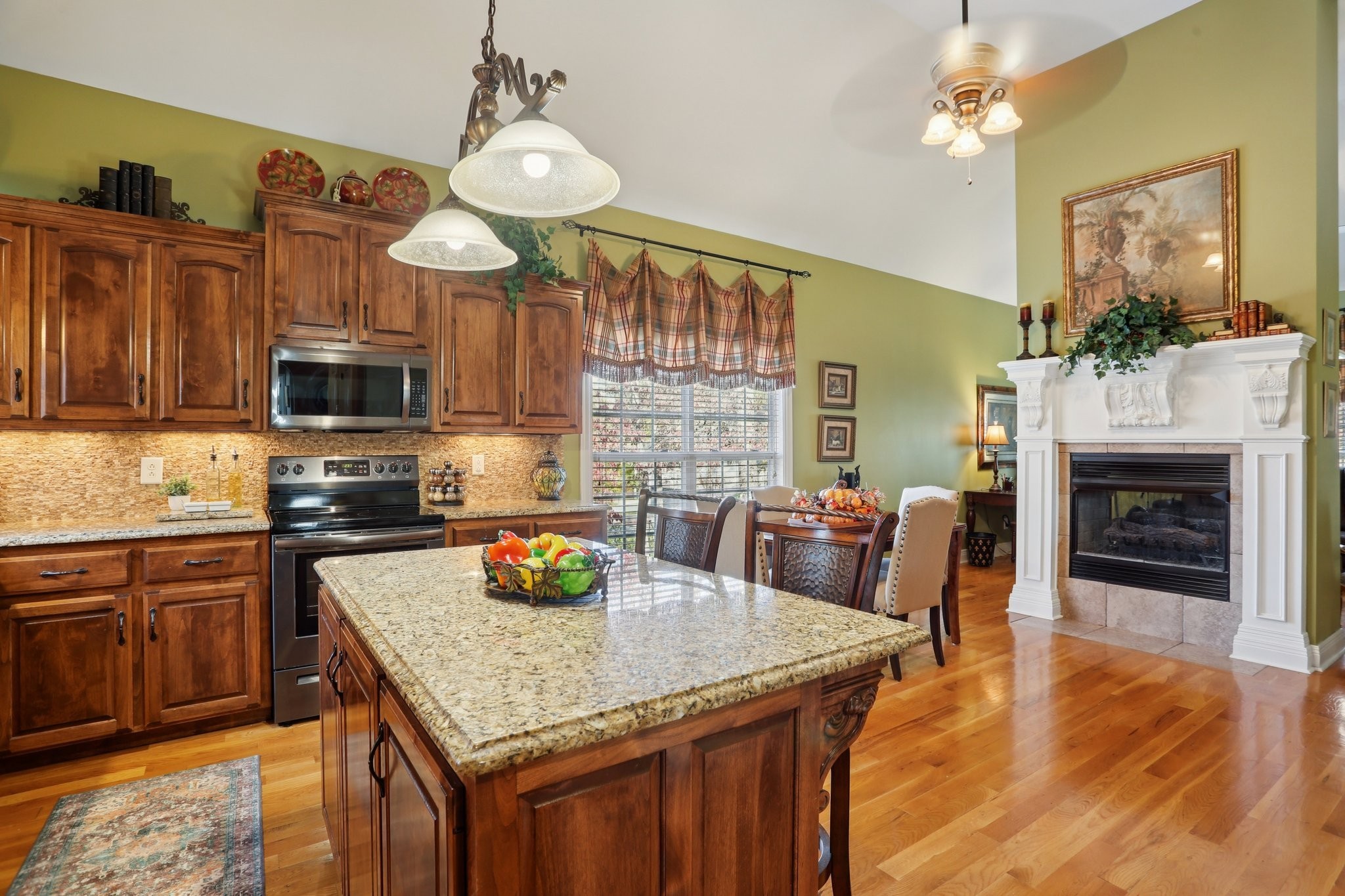 4015 Pilgrim Trail Greenbrier, TN 37073 - Photo 23 of 76 a kitchen with granite countertop a stove cabinets and dining table with wooden floor