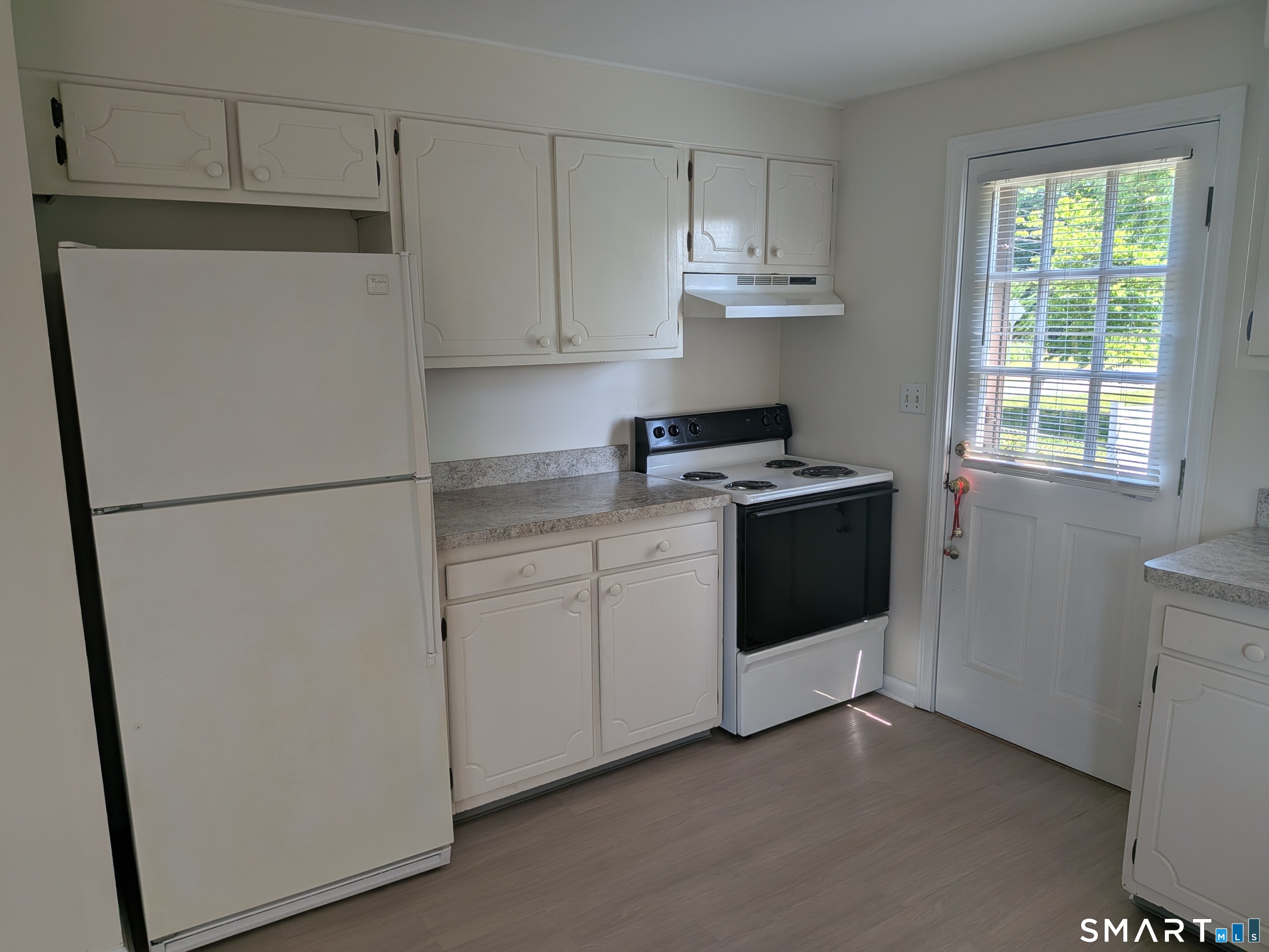 124 Spring Lake Road Waterbury, CT 06706 - Photo 5 of 34 Kitchen closeup of working area and view of side entrance off driveway