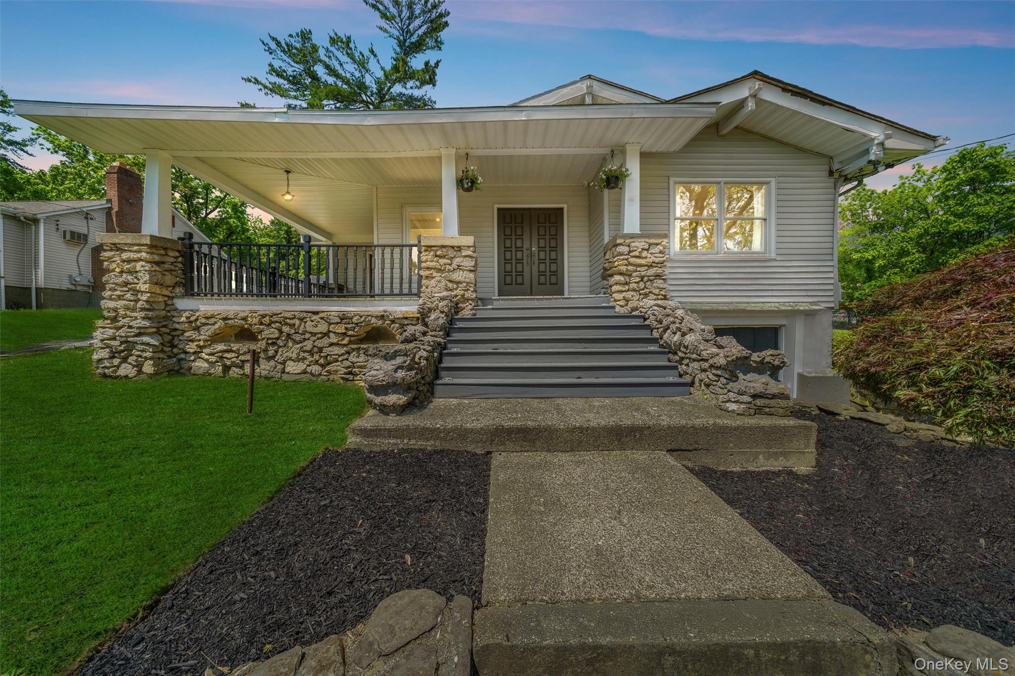 a front view of a house with a garden