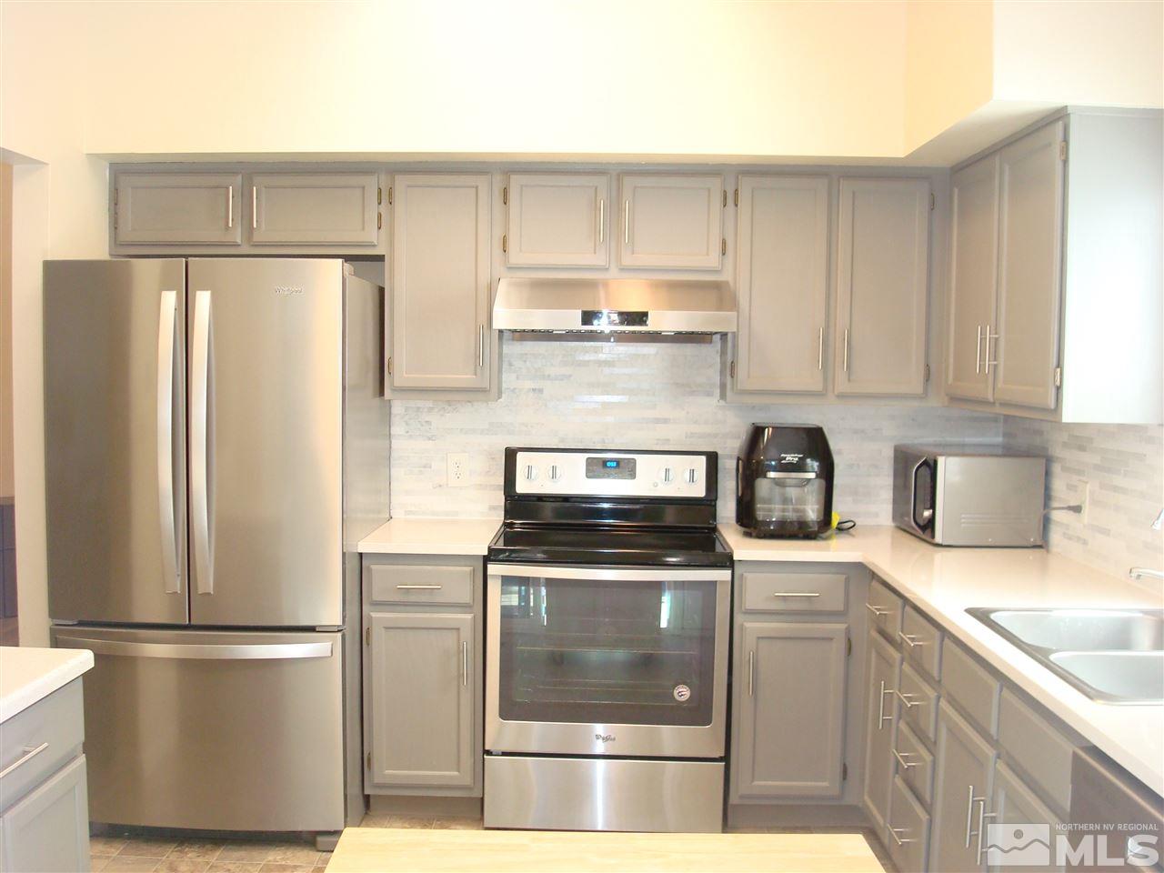 6234 Chesterfield Lane Reno, NV 89523 - Photo 5 of 11 a kitchen with a refrigerator sink and cabinets