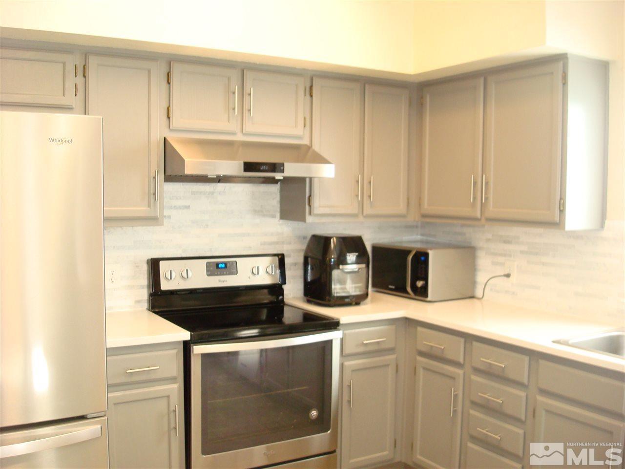 6234 Chesterfield Lane Reno, NV 89523 - Photo 6 of 11 a kitchen with stainless steel appliances granite countertop a stove a microwave and cabinets