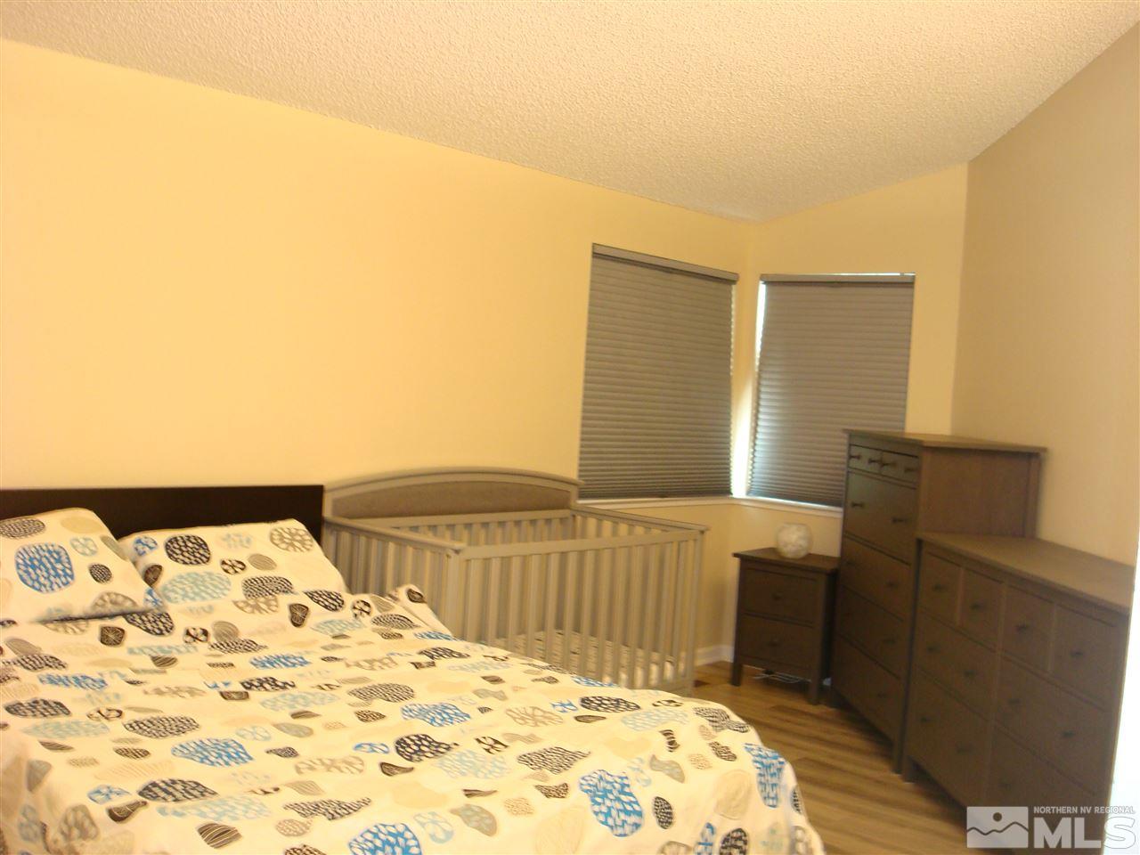 6234 Chesterfield Lane Reno, NV 89523 - Photo 10 of 11 a bedroom with a bed and wooden floor