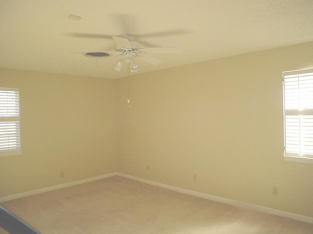 4315 Arden Road Amarillo, TX 79110 - Photo 4 of 11 an empty room with a window and a ceiling fan