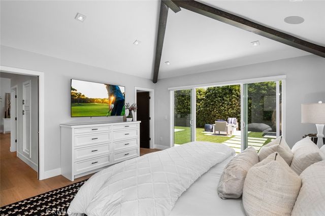 a bedroom with a bed and large windows