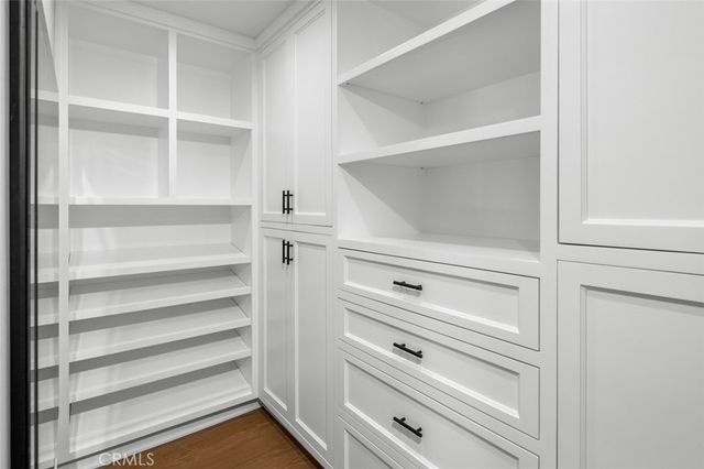a view of walk in closet with empty racks