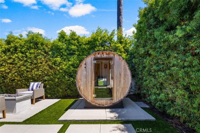 a view of a small yard with large trees and plants