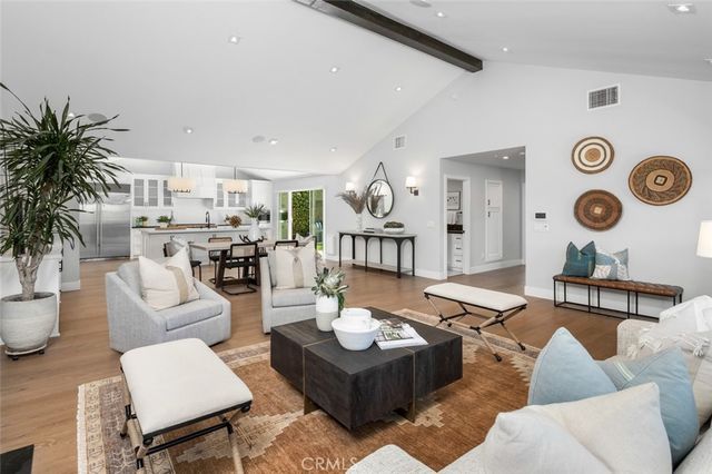 a living room with furniture and view of kitchen