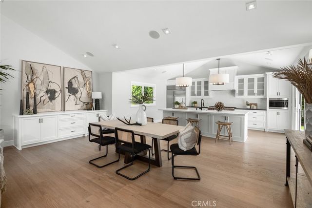 a living room with furniture kitchen view and a large window