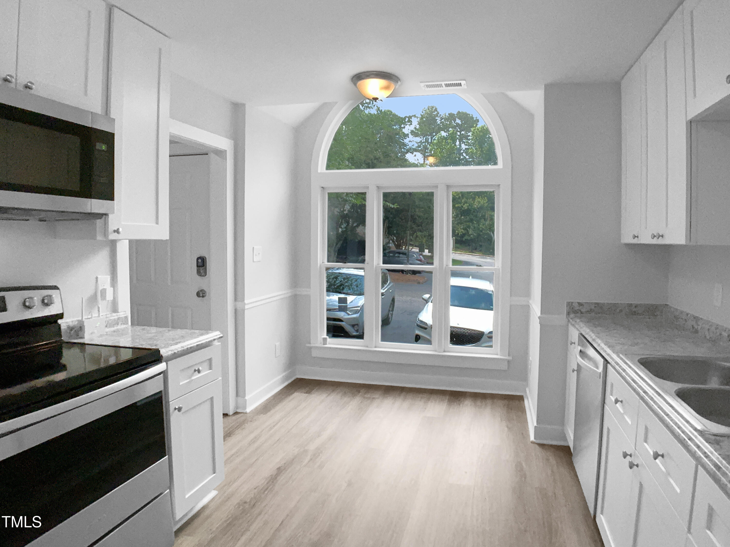 1432 Quarter Point Raleigh, NC 27615 - Photo 15 of 25 a kitchen with a stove a sink and a microwave