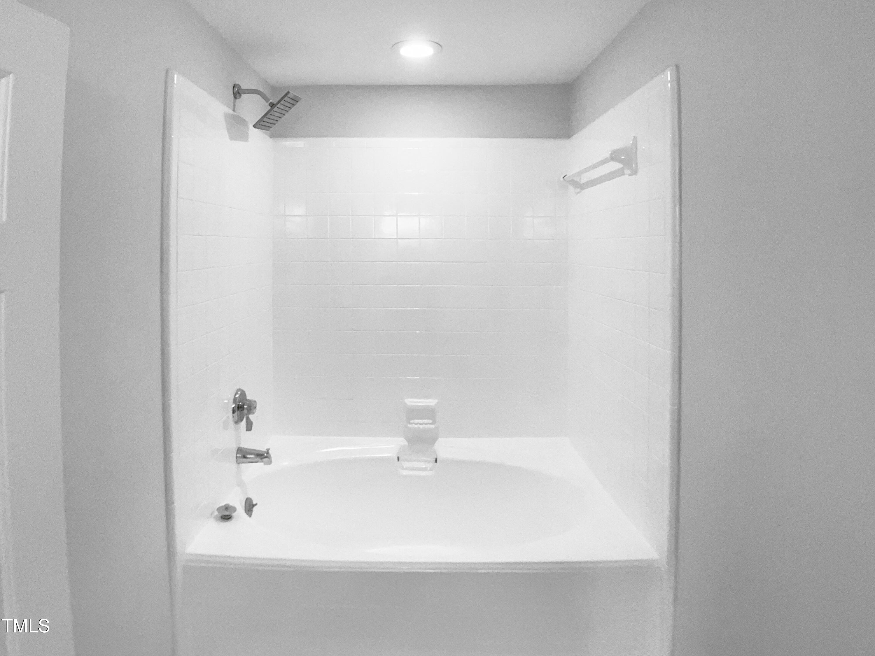 1432 Quarter Point Raleigh, NC 27615 - Photo 19 of 25 a bathroom with a bathtub and a sink