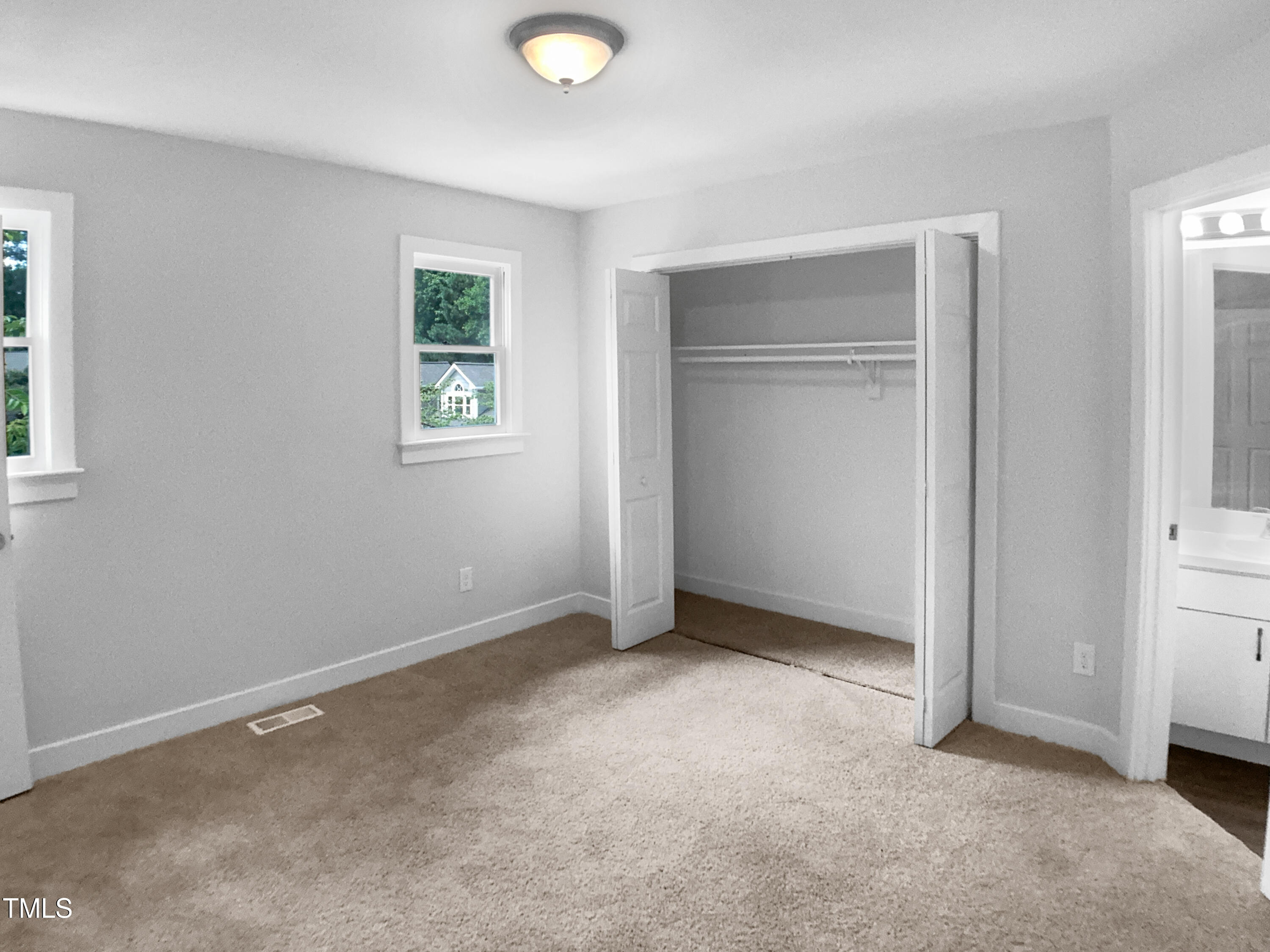 1432 Quarter Point Raleigh, NC 27615 - Photo 21 of 25 an empty room with windows