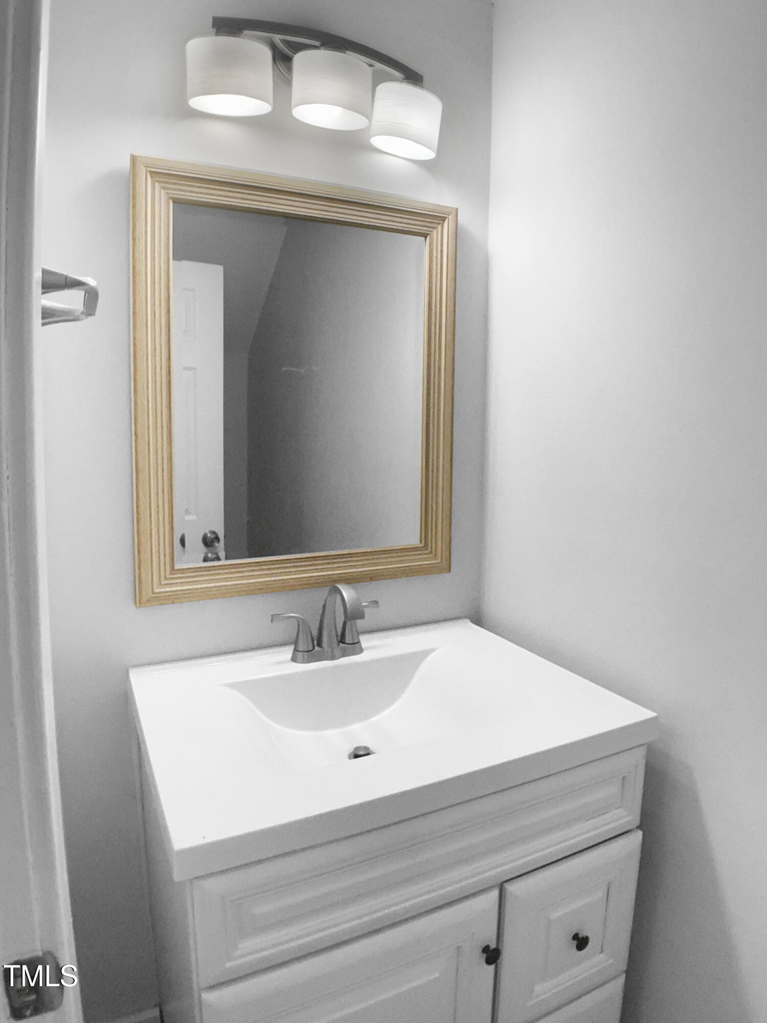 1432 Quarter Point Raleigh, NC 27615 - Photo 23 of 25 a bathroom with a sink and a mirror