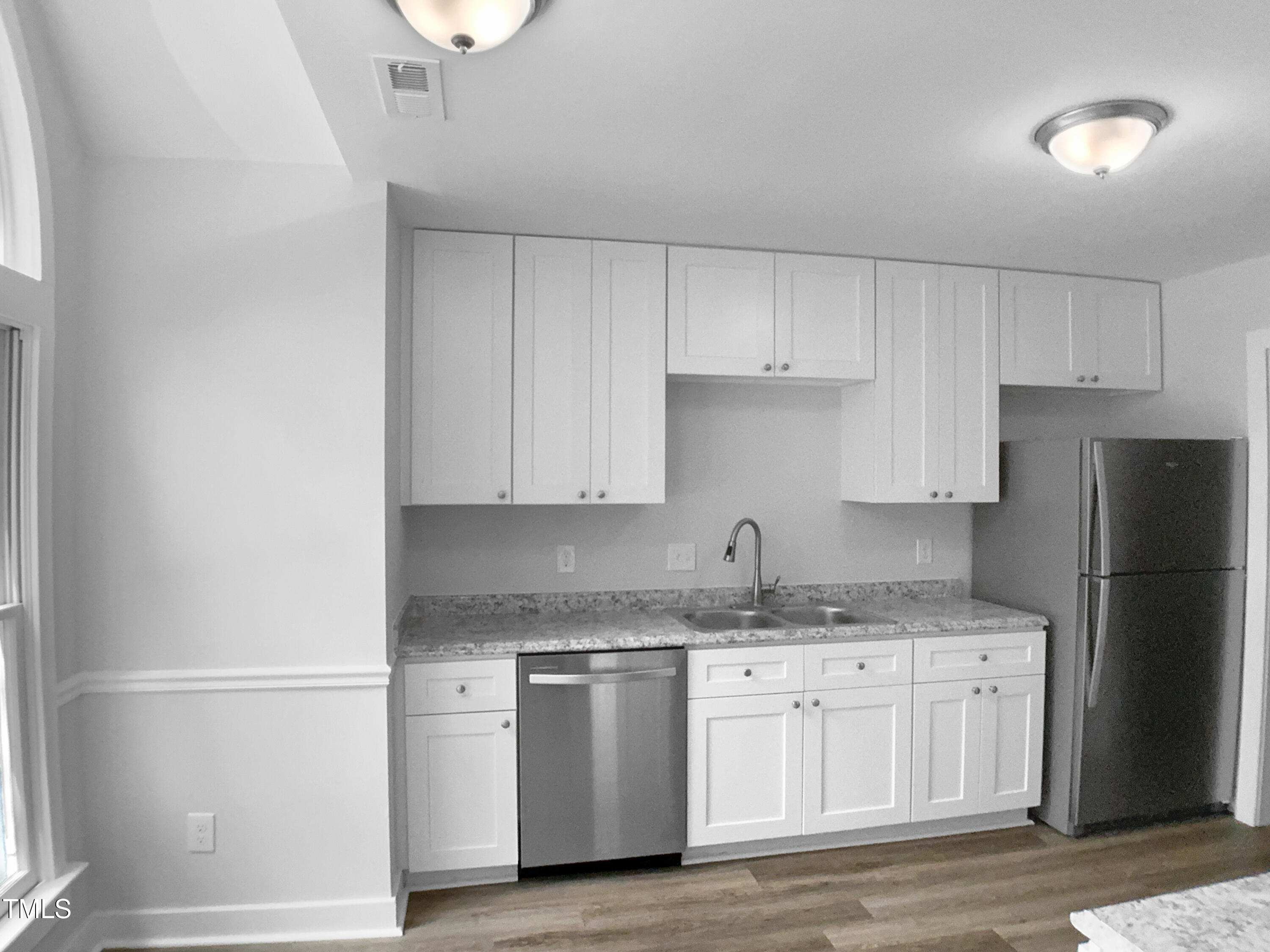 1432 Quarter Point Raleigh, NC 27615 - Photo 24 of 25 a kitchen with a refrigerator sink and cabinets