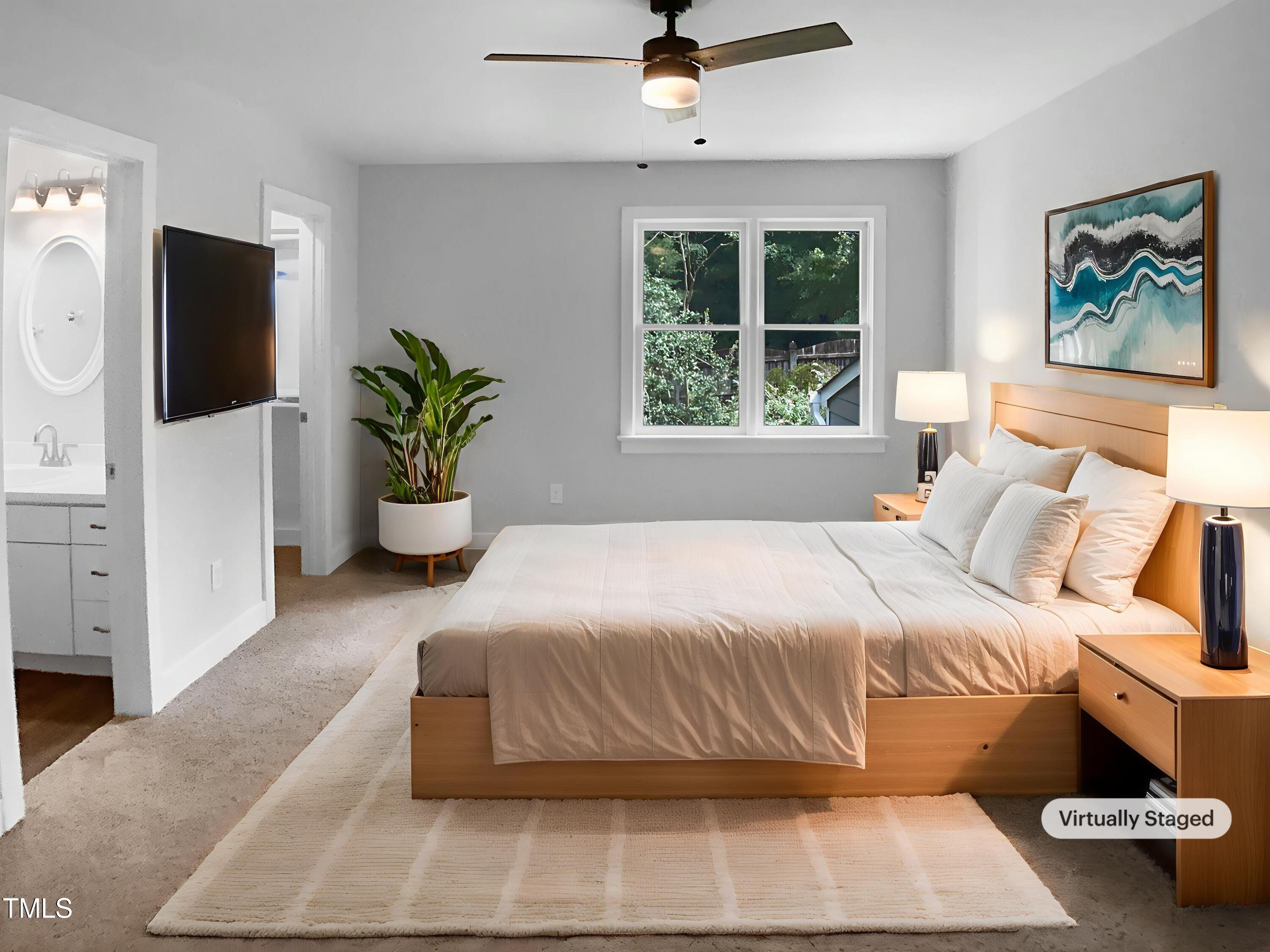 1432 Quarter Point Raleigh, NC 27615 - Photo 4 of 25 a bedroom with a large bed and a potted plant