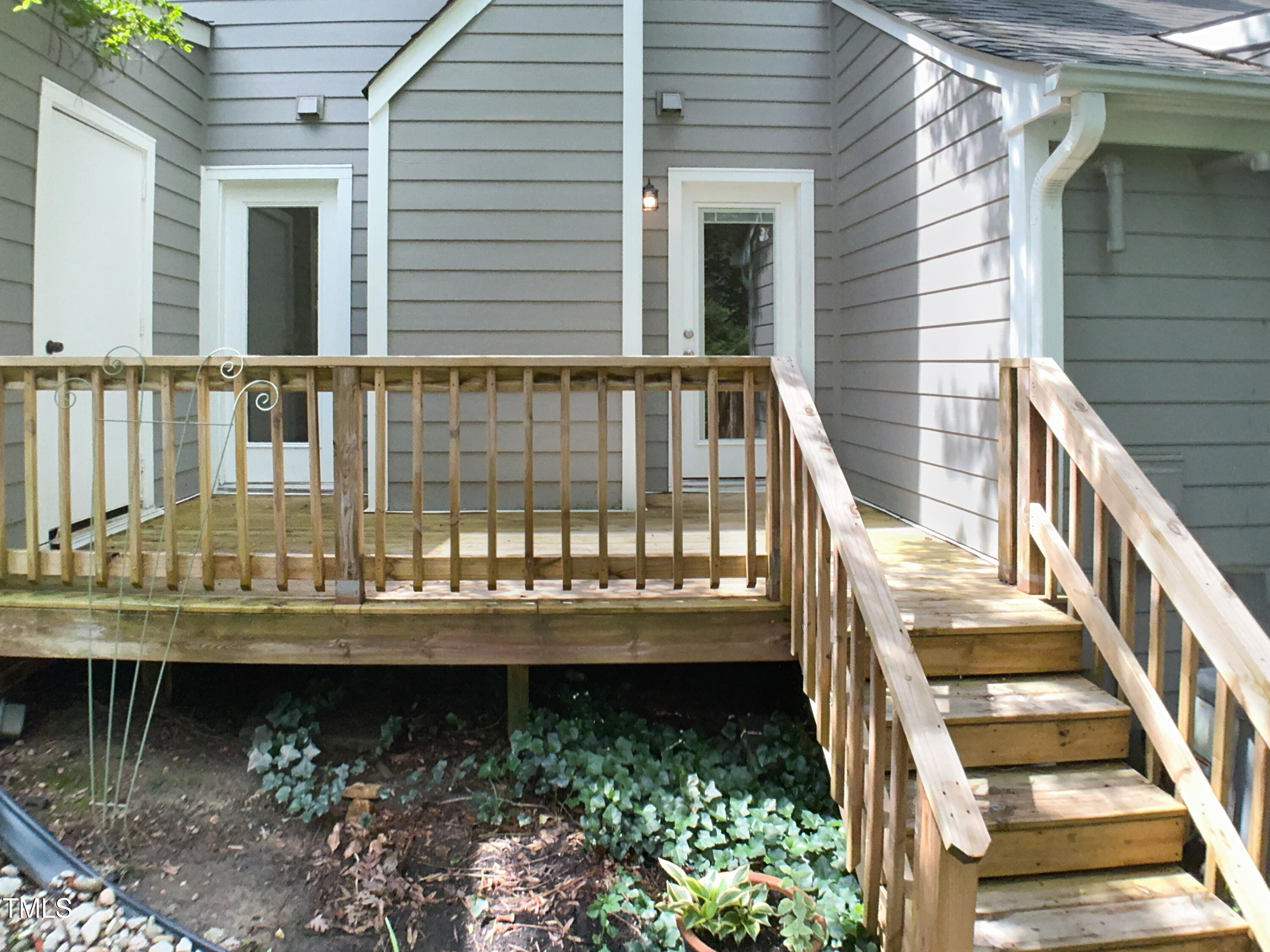 1432 Quarter Point Raleigh, NC 27615 - Photo 8 of 25 a view of a house with large windows and a small yard