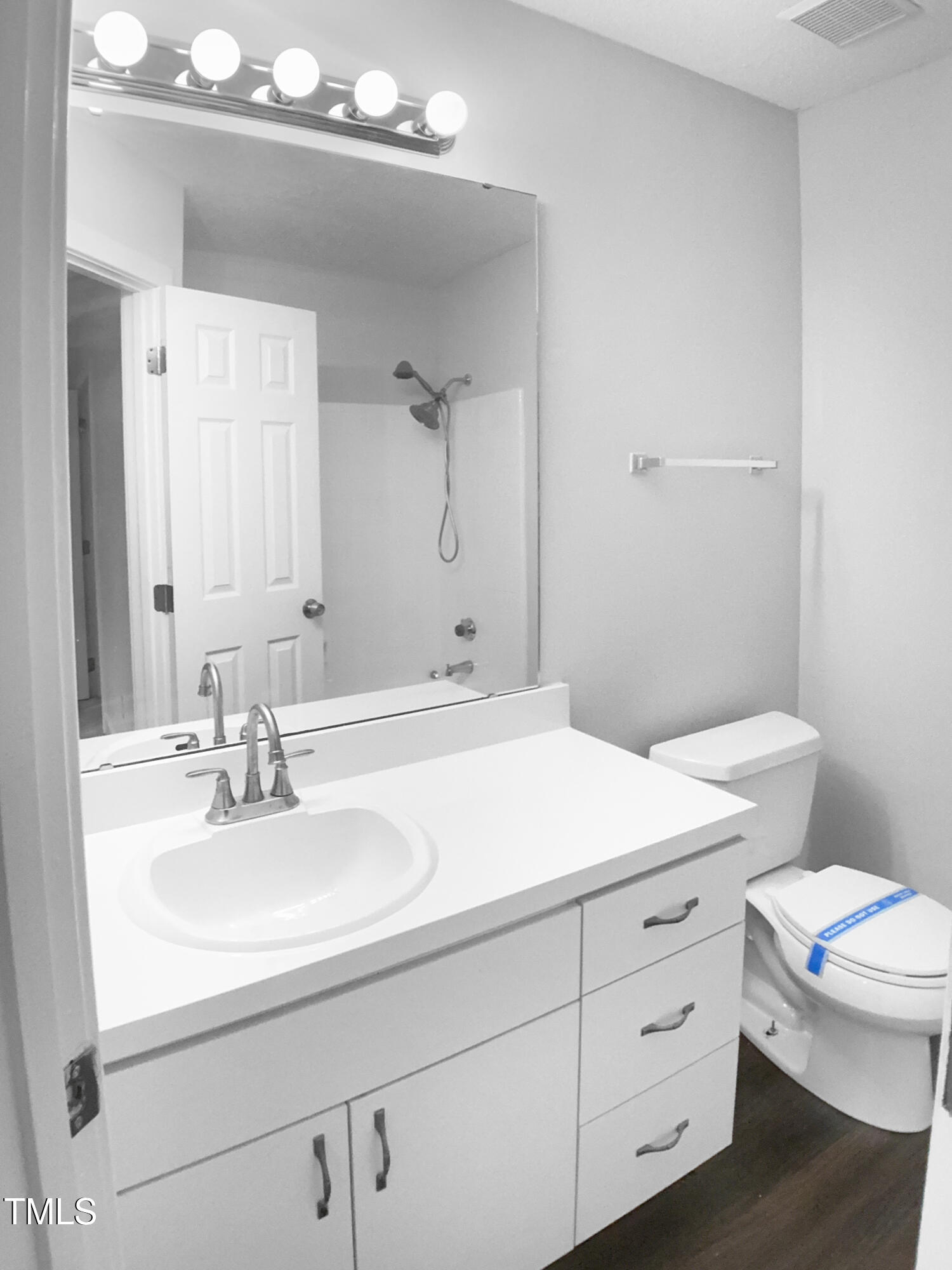 1432 Quarter Point Raleigh, NC 27615 - Photo 9 of 25 a bathroom with a sink a toilet and mirror