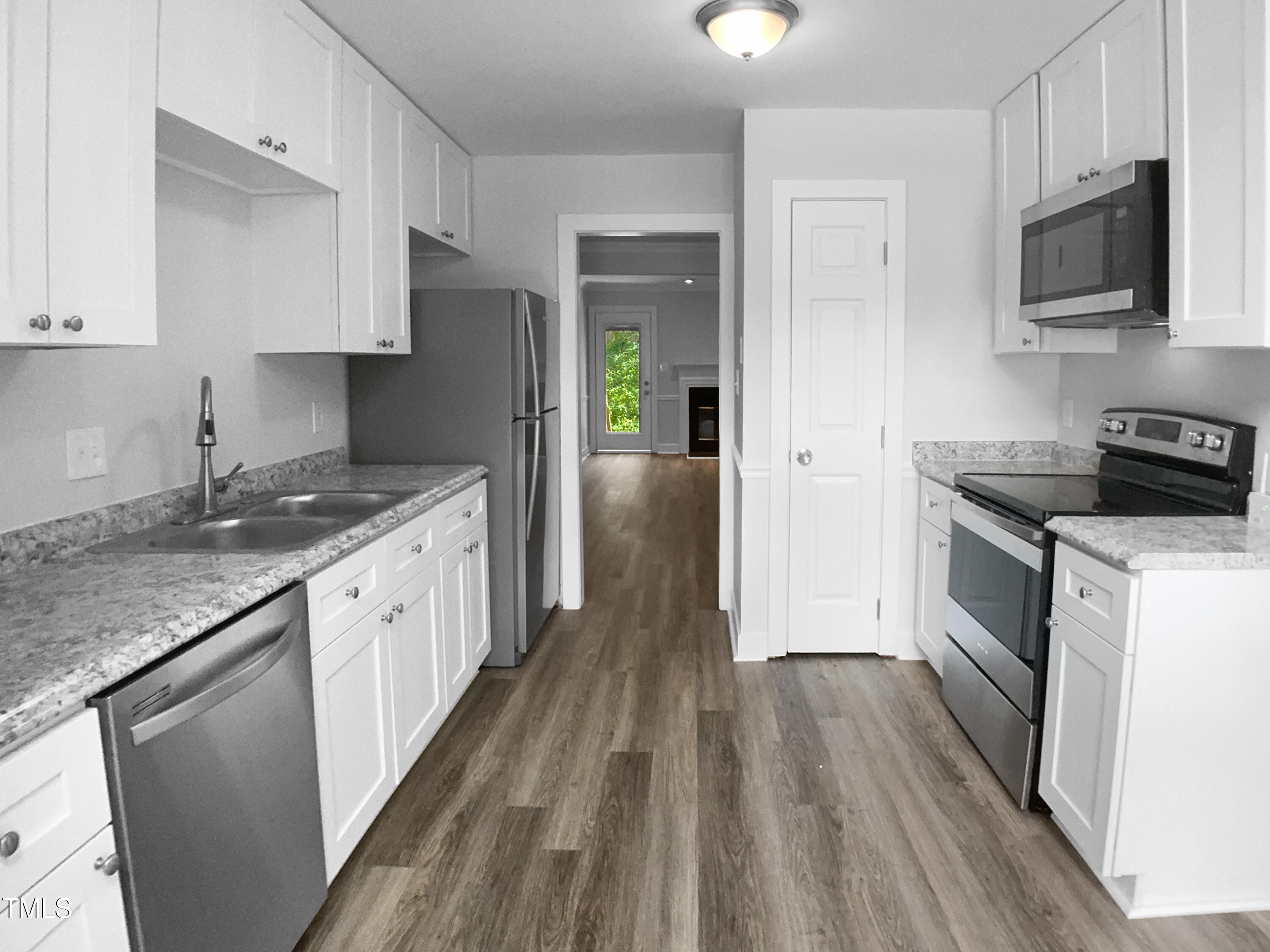 1432 Quarter Point Raleigh, NC 27615 - Photo 10 of 25 a kitchen with a sink stove and refrigerator