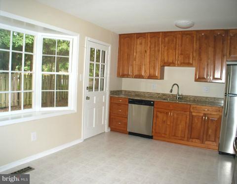 9700 Brookford Road Potomac, MD 20854 - Photo 11 of 29 a kitchen with granite countertop a sink stainless steel appliances and cabinets