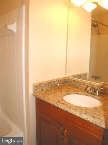 9700 Brookford Road Potomac, MD 20854 - Photo 15 of 29 a bathroom with a granite countertop sink and a mirror