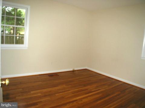 9700 Brookford Road Potomac, MD 20854 - Photo 17 of 29 a view of an empty room with wooden floor and windows