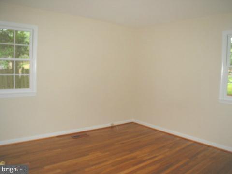 9700 Brookford Road Potomac, MD 20854 - Photo 18 of 29 an empty room with wooden floor and windows