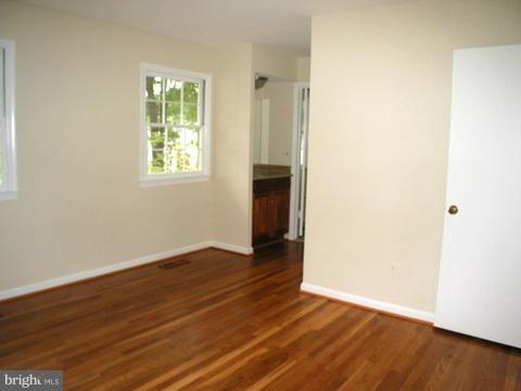 9700 Brookford Road Potomac, MD 20854 - Photo 20 of 29 an empty room with wooden floor and windows