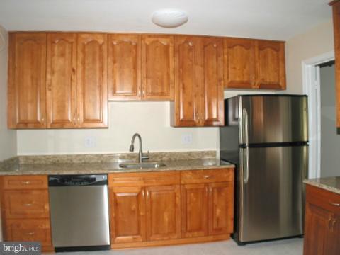 9700 Brookford Road Potomac, MD 20854 - Photo 9 of 29 a kitchen with stainless steel appliances granite countertop a refrigerator a sink and a counter space