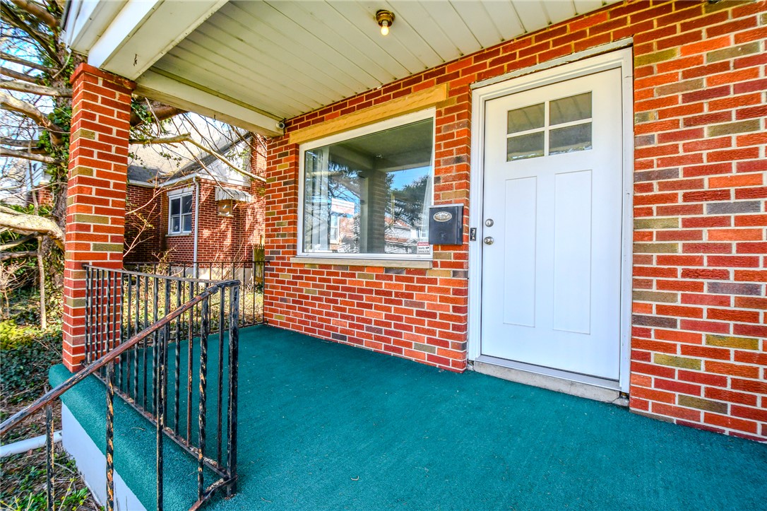 816 South Smithville Road Dayton, OH 45403 - Photo 5 of 33 This charming residence features a welcoming entrance with classic brickwork and an inviting porch.