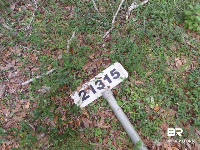 21315 East Lay Lane Foley, AL 36535 - Photo 7 of 10 Address sign laying alongside front of property.