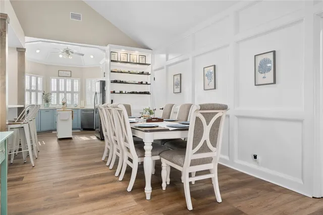 a dining room with furniture and wooden floor