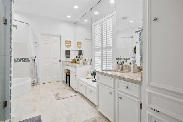 a bathroom with a bathtub and a shower
