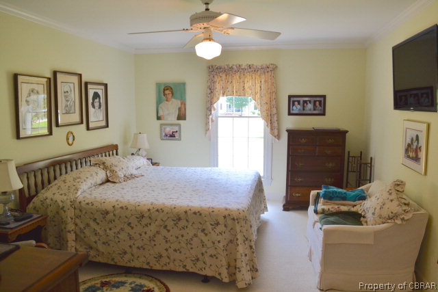 10306 Buckley Hall Road Mathews, VA 23109 - Photo 11 of 22 a bedroom with a bed and furniture