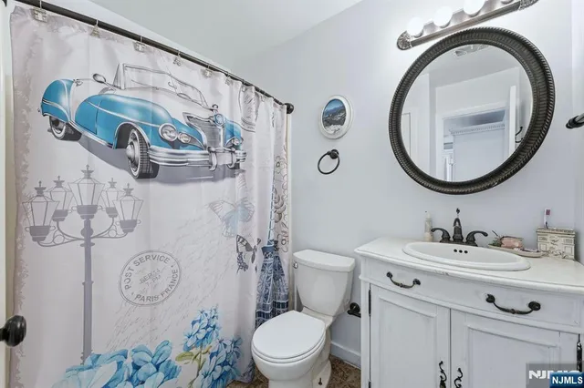 a bathroom with a toilet a sink and a mirror