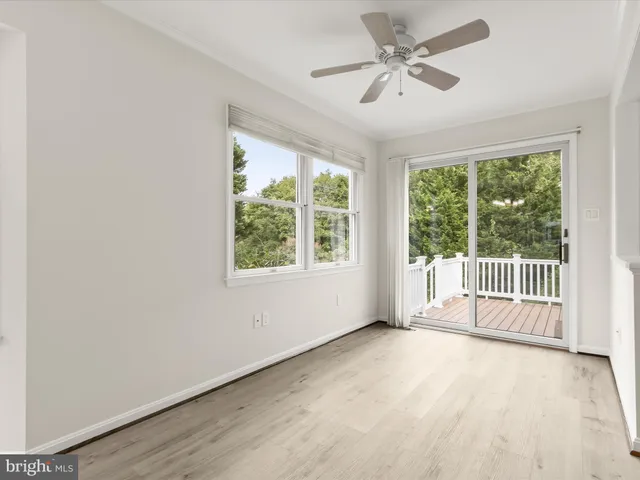 a view of a kitchen area with furniture and wooden floor