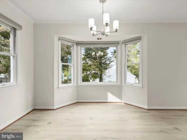 a kitchen with stainless steel appliances granite countertop a sink window and cabinets