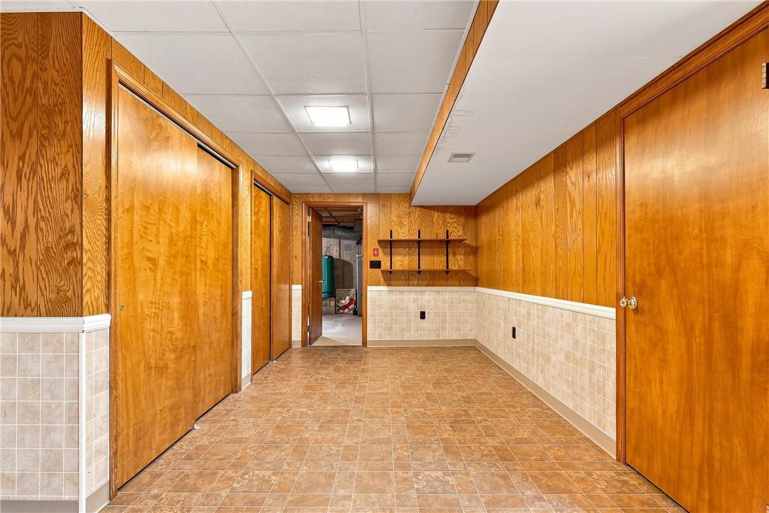 6090 Stone Post Road Bath, PA 18014 - Photo 41 of 57 A versatile finished basement offers ample storage behind sliding doors and convenient built-in shelving.
