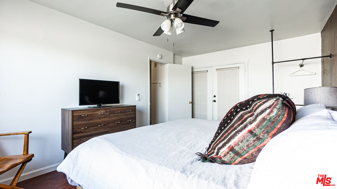 62033 Bonair Road Joshua Tree, CA 92252 - Photo 25 of 53 a bedroom with a bed and a flat screen tv