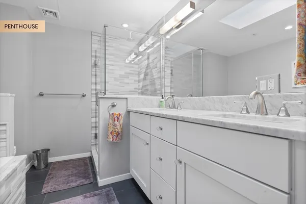 a bathroom with a sink double vanity and a shower