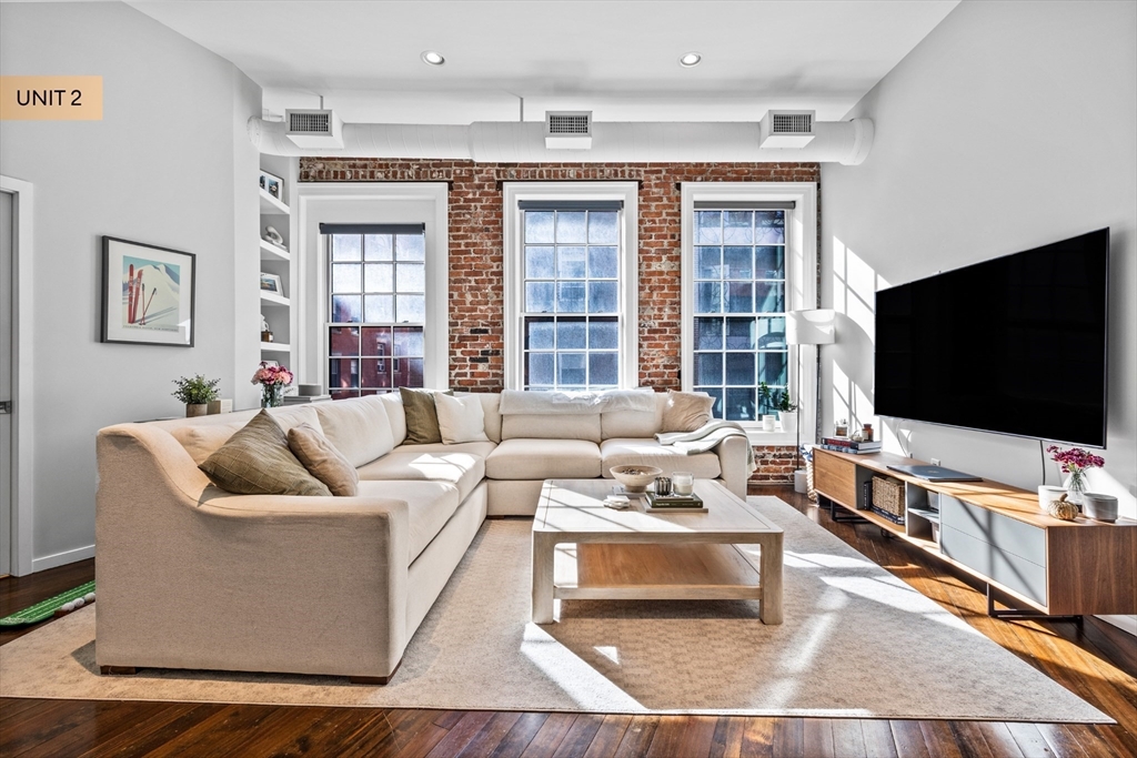 133 Salem Street Boston, MA 02113 - Photo 16 of 27 a living room with furniture and a flat screen tv