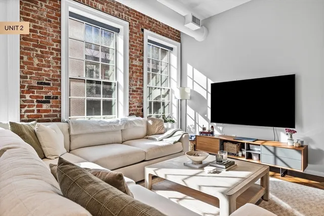 a room with lots of wooden furniture and a chandelier