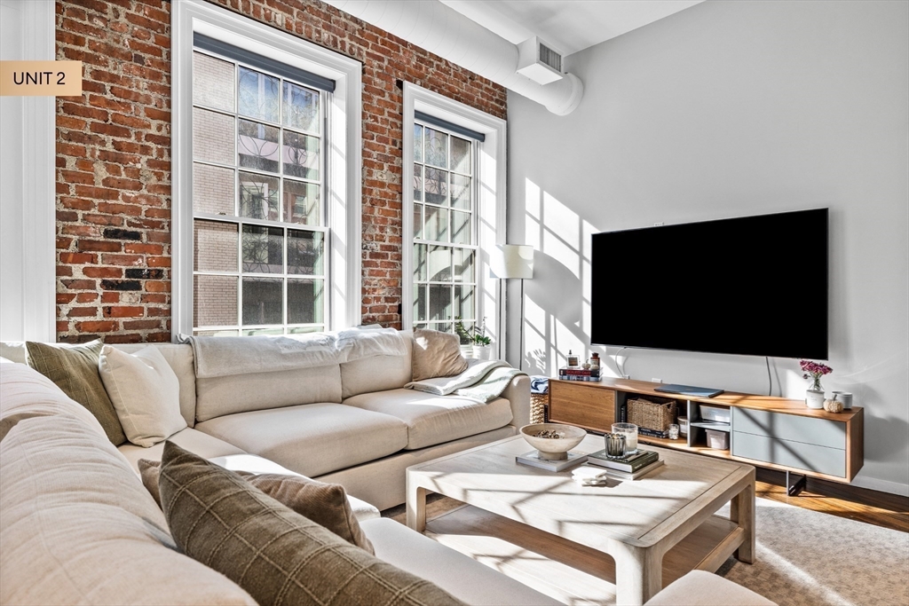 133 Salem Street Boston, MA 02113 - Photo 17 of 27 a living room with furniture and a flat screen tv